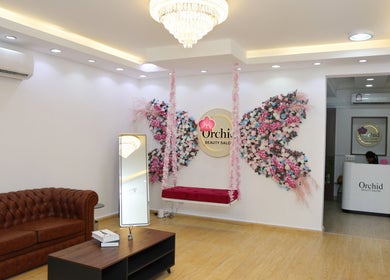 Elegant interior of Orchid Beauty salon for Ladies, Ar-rayyan, QA, showcasing luxurious seating and floral decor.