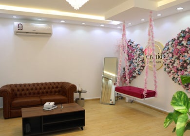 Stylish lounge at Orchid Beauty salon for Ladies, Ar-rayyan, featuring floral decor and plush seating.