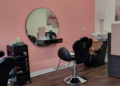 Interior of Ru’s Brow and Beauty Studio, Huntingdon, England, GB with elegant styling chairs and large mirrors.