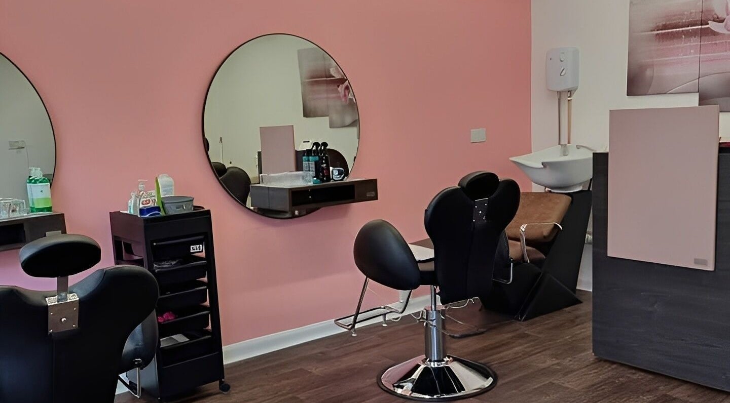 Interior of Ru’s Brow and Beauty Studio, Huntingdon, England, GB with elegant styling chairs and large mirrors.