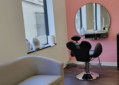 Bright, modern interior of Ru’s Brow and Beauty Studio in Huntingdon, England, GB with stylish seating and mirror.