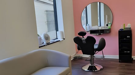 Bright, modern interior of Ru’s Brow and Beauty Studio in Huntingdon, England, GB with stylish seating and mirror.