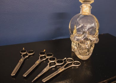 Stylish scissors and a skull bottle at The Cutting Club, Louth, England, GB. Unique salon decor.