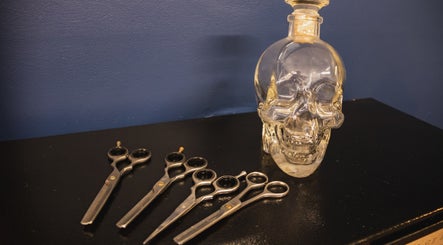 Stylish scissors and a skull bottle at The Cutting Club, Louth, England, GB. Unique salon decor.