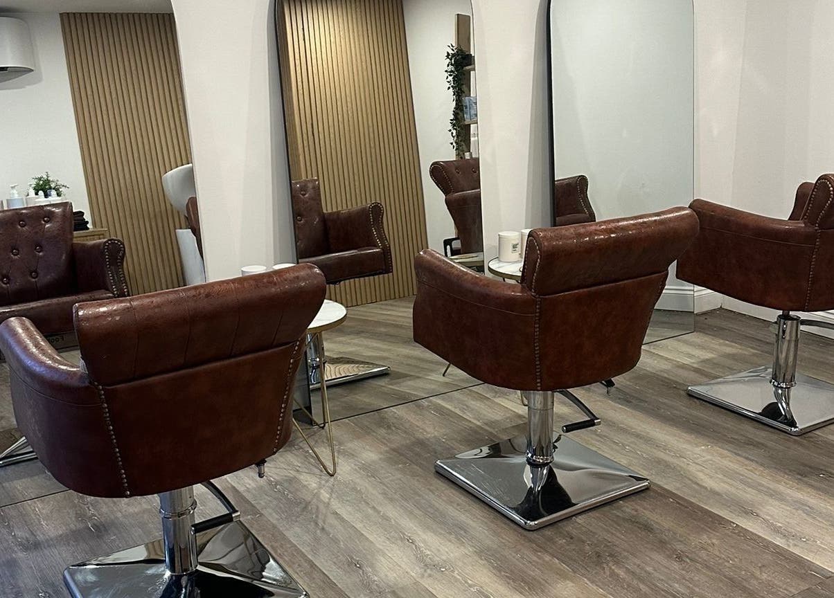 Modern salon seating at C.B Colour, Portishead, England, GB with stylish leather chairs and mirrors.