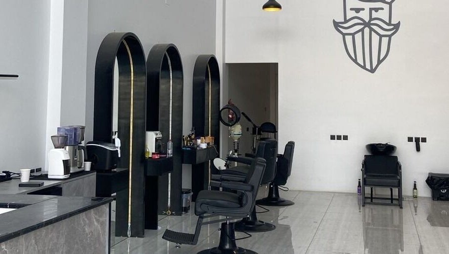 Interior of Alfa Barber - حلاق ألفا, Buraydah, Al Qassim Province, SA, featuring stylish chairs and decor.