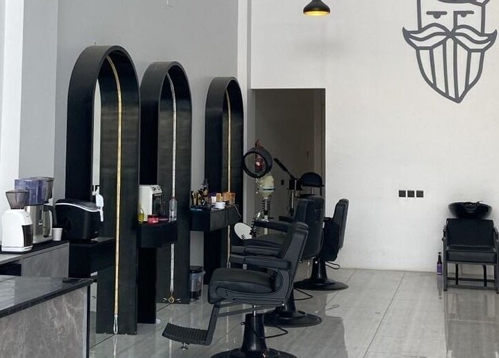Interior of Alfa Barber - حلاق ألفا, Buraydah, Al Qassim Province, SA, featuring stylish chairs and decor.