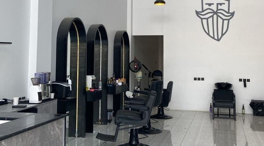 Interior of Alfa Barber - حلاق ألفا, Buraydah, Al Qassim Province, SA, featuring stylish chairs and decor.