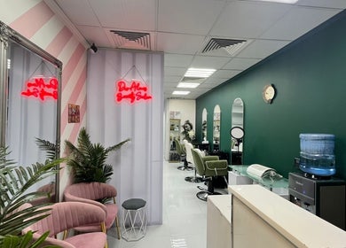 Chic interior of Dar Almas Beauty Salon in Dubai, Dubai, AE with stylish chairs and neon sign.