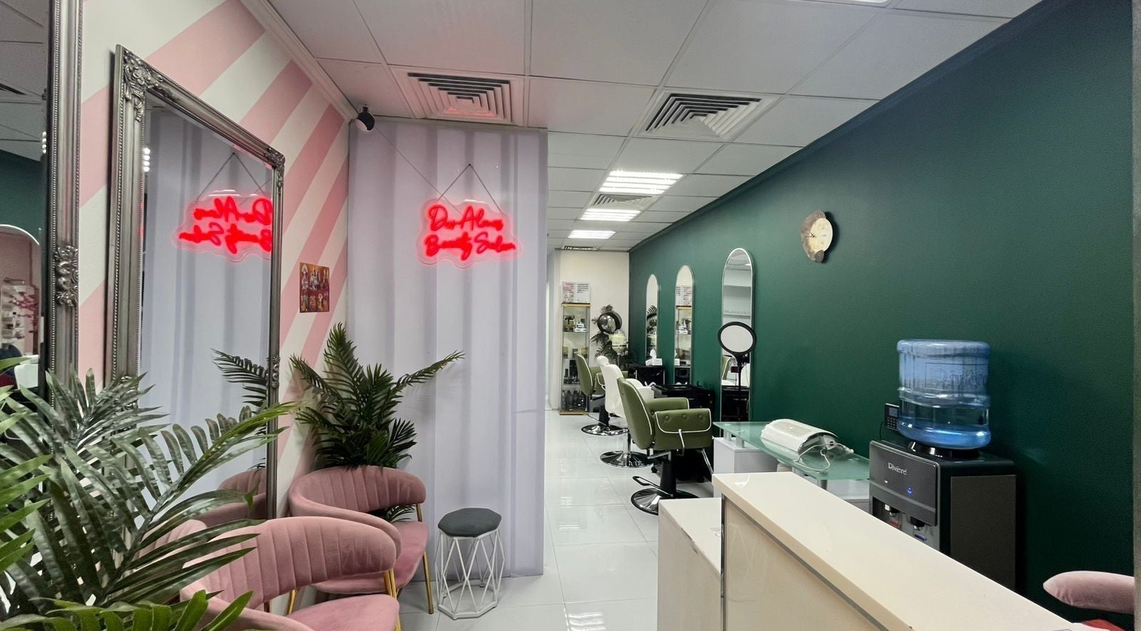 Chic interior of Dar Almas Beauty Salon in Dubai, Dubai, AE with stylish chairs and neon sign.