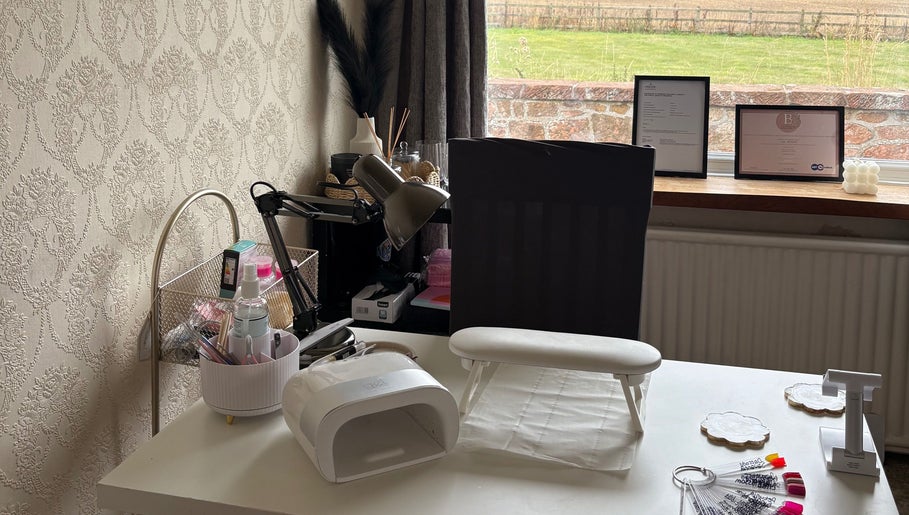 A stylish nail station at The Nail Garden, Old Woods, Bomere Heath, England, featuring nail tools and decor.