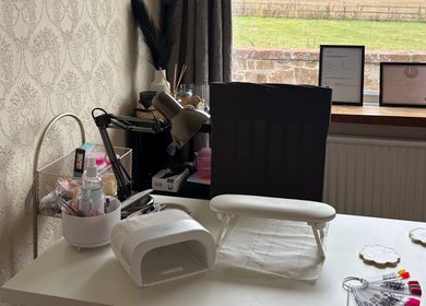 A stylish nail station at The Nail Garden, Old Woods, Bomere Heath, England, featuring nail tools and decor.