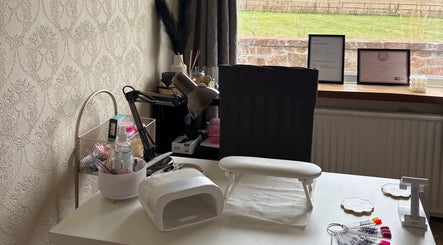 A stylish nail station at The Nail Garden, Old Woods, Bomere Heath, England, featuring nail tools and decor.
