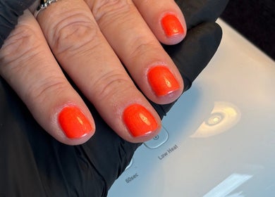 Bright orange manicure at The Nail Garden, Old Woods, Bomere Heath, England, GB.
