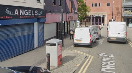 Bysophiew street view in Sunderland, England, GB, featuring local businesses and parked vehicles.