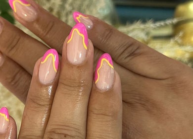 Bright pink and yellow nail art at Beauty Style Salon, Merstham, England, GB showcasing creative designs.