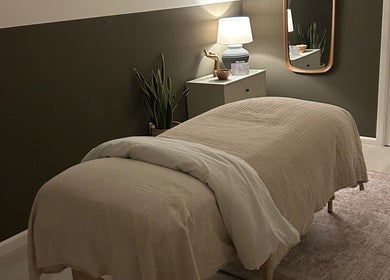 Cozy therapy room at Skin And Soul, New Milton, England, GB with a massage bed and warm lighting.