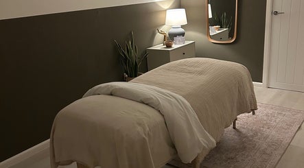 Cozy therapy room at Skin And Soul, New Milton, England, GB with a massage bed and warm lighting.