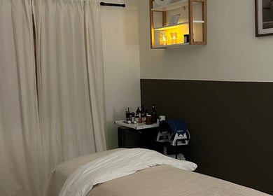 Relaxing treatment room at Skin And Soul, New Milton, England, GB, with a massage bed and soft lighting.