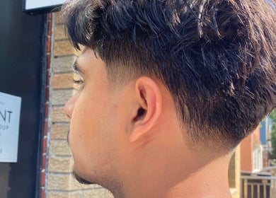 Close-up of a stylish fade haircut at Magic_cut in New York, New York, US, vibrant and trendy.