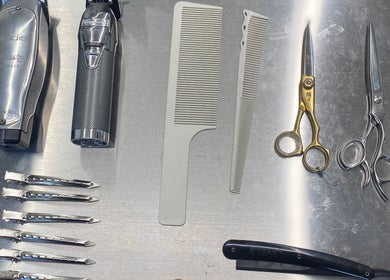 Hair styling tools at Magic_cut, New York, New York, US, showcasing professional scissors and combs.