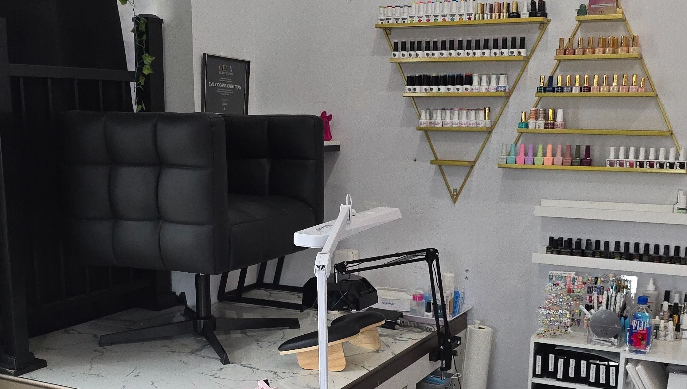 Artsy Digits Nails seating and polish display in Hamilton, Ontario, CA, showcasing a modern nail salon interior.