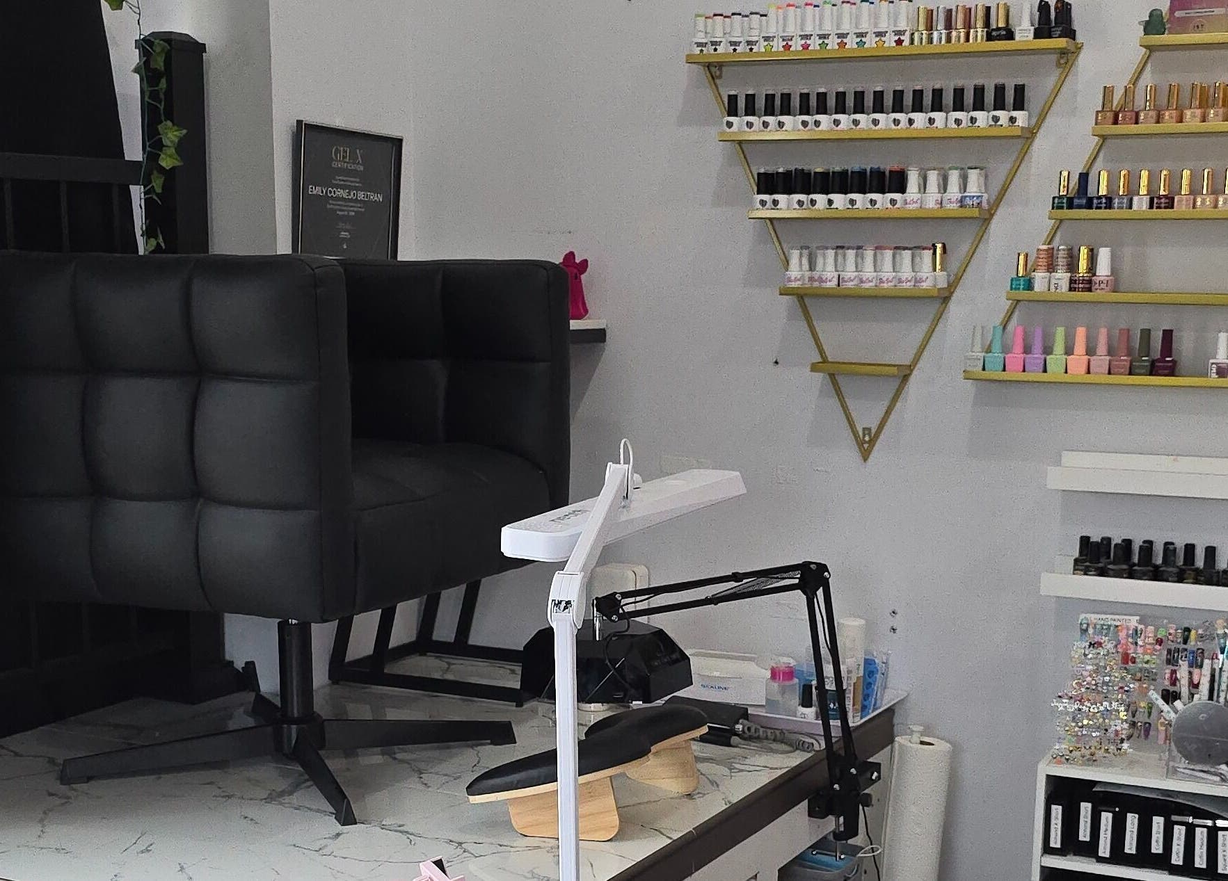 Artsy Digits Nails seating and polish display in Hamilton, Ontario, CA, showcasing a modern nail salon interior.