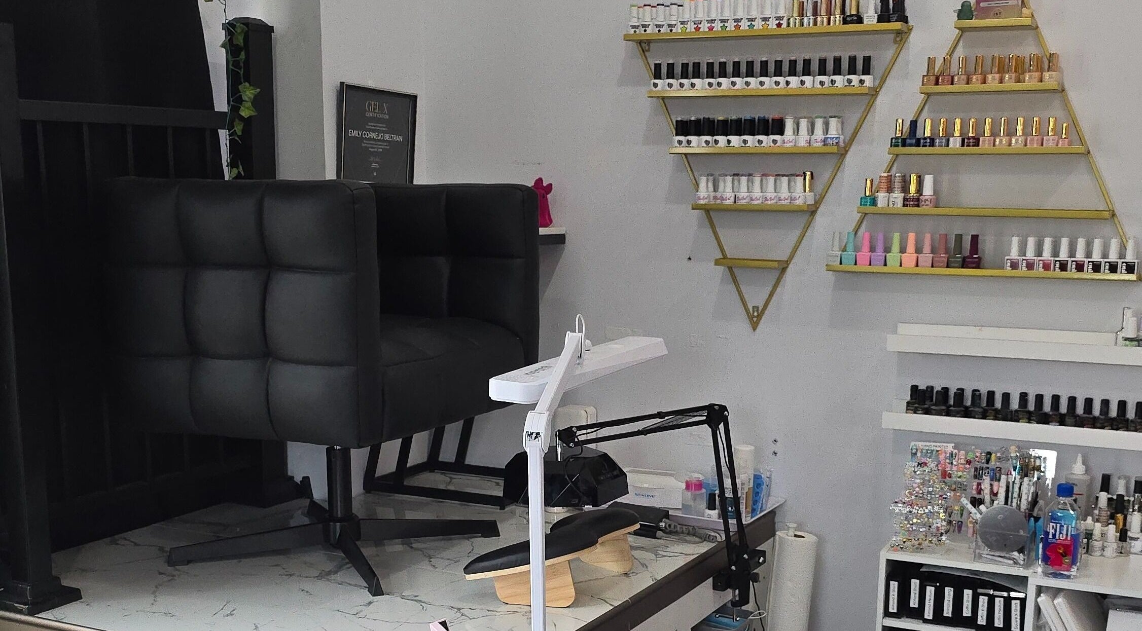 Artsy Digits Nails seating and polish display in Hamilton, Ontario, CA, showcasing a modern nail salon interior.