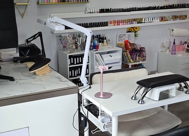 Modern nail studio setup at Artsy Digits Nails in Hamilton, Ontario, CA with manicure stations and polish display.