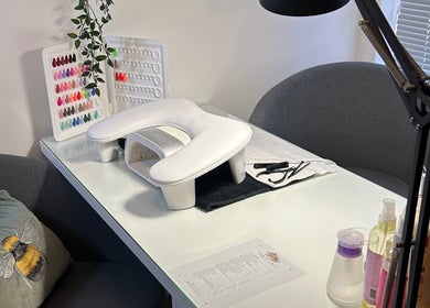 Elegant nail setup at Poppy’s beauty room, Pulborough, England, GB with a variety of polish colors displayed.