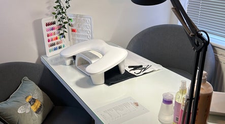 Elegant nail setup at Poppy’s beauty room, Pulborough, England, GB with a variety of polish colors displayed.