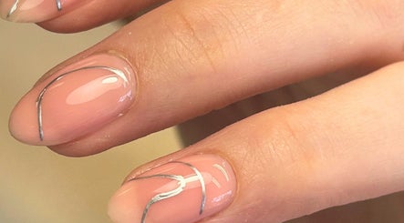 Close-up of elegant pink nails with silver lines at Poppy’s beauty room, Pulborough, England, GB.