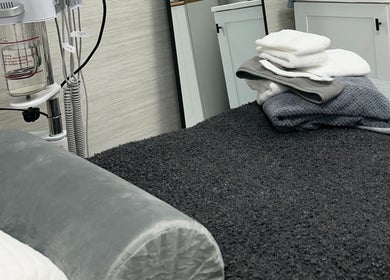 Relaxing spa treatment room at Saona Beauty Clinic, Pembroke Pines, Florida, US with fresh towels and equipment.