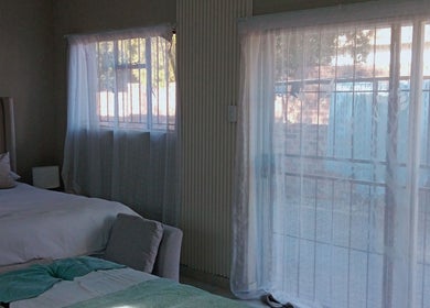 Tranquil bedroom at Nomngoma Royal Spa, Emalahleni, Mpumalanga, ZA, featuring soft lighting and elegant decor.