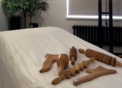 Wooden massage tools on a treatment bed at Figured It, Hessle, England, GB.