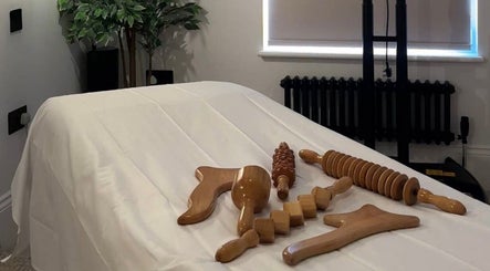 Wooden massage tools on a treatment bed at Figured It, Hessle, England, GB.