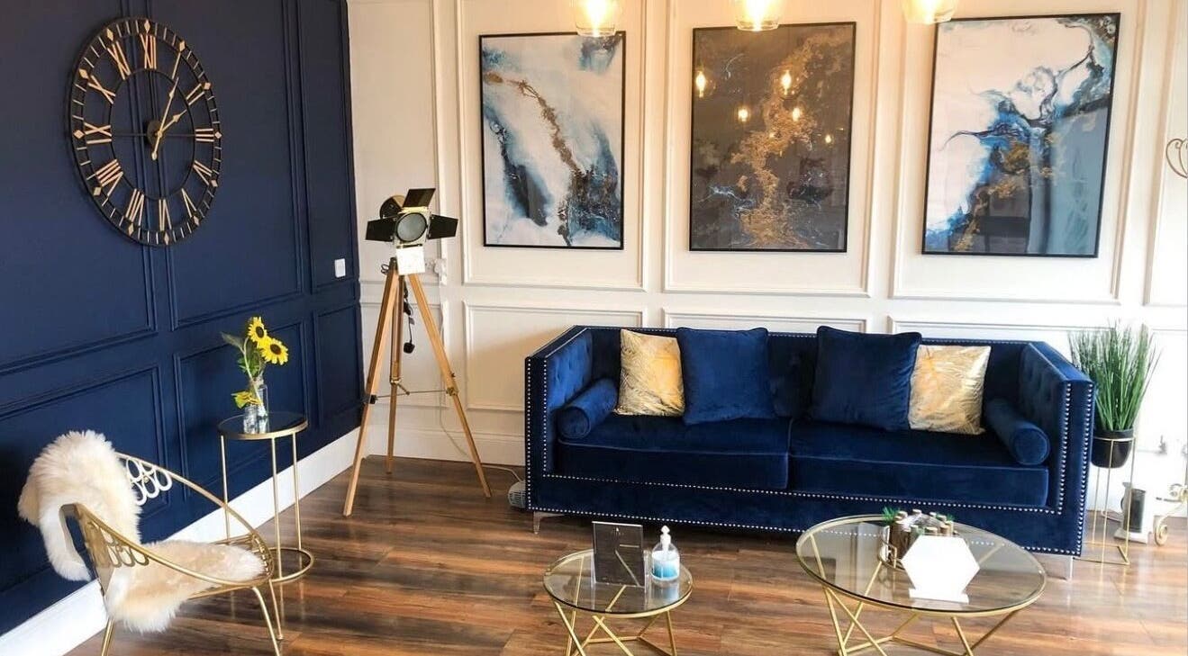 Chic lounge area at Pure Skin Clinic Hessle, Hull, England, GB with blue sofa and modern decor.