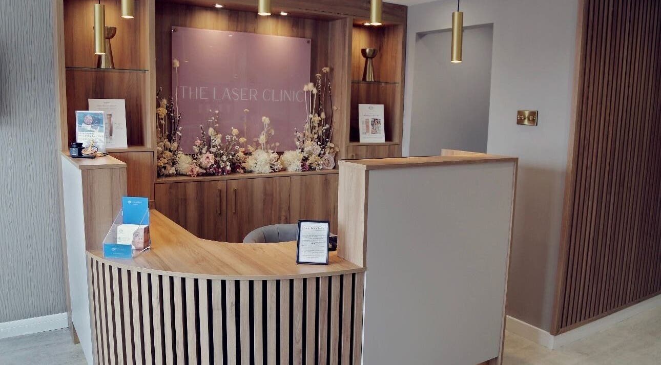 Reception area of Figured It at The Laser Clinic Anlaby, Anlaby Common, England, GB with wood decor and floral accents.