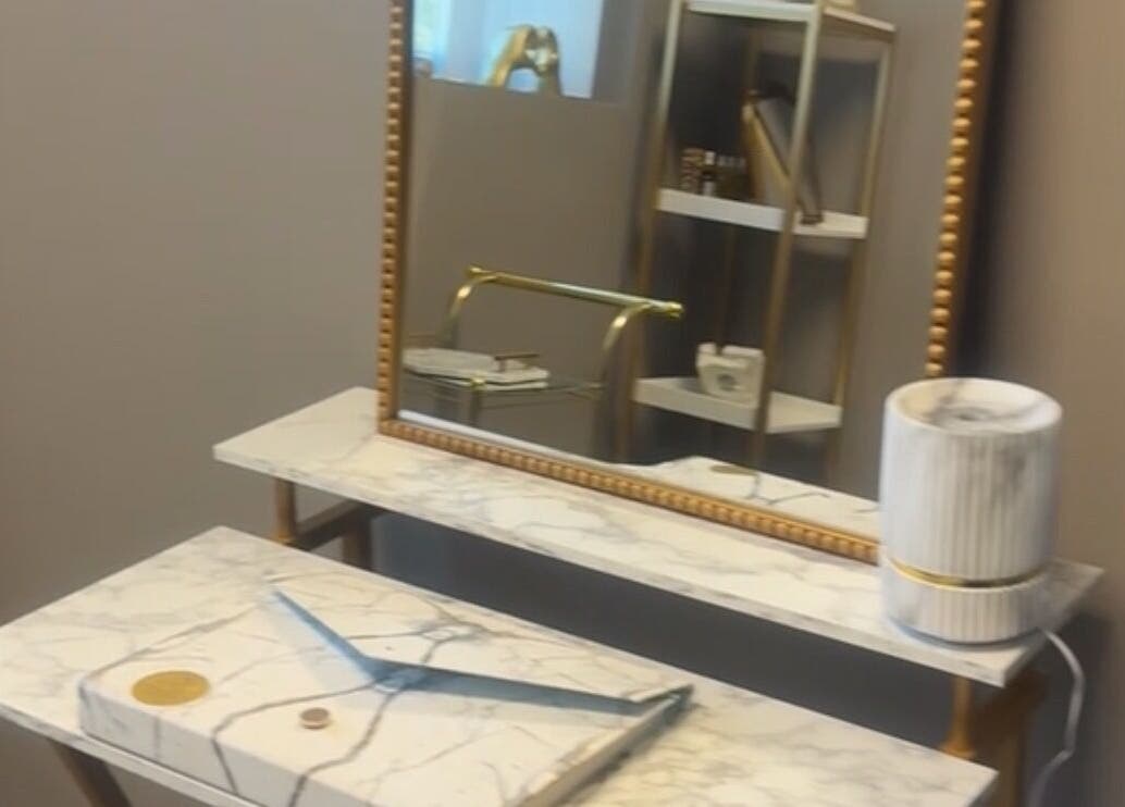 Elegant marble vanity with gold accents at Nduljé By Ebony in Crestview, Florida, US.