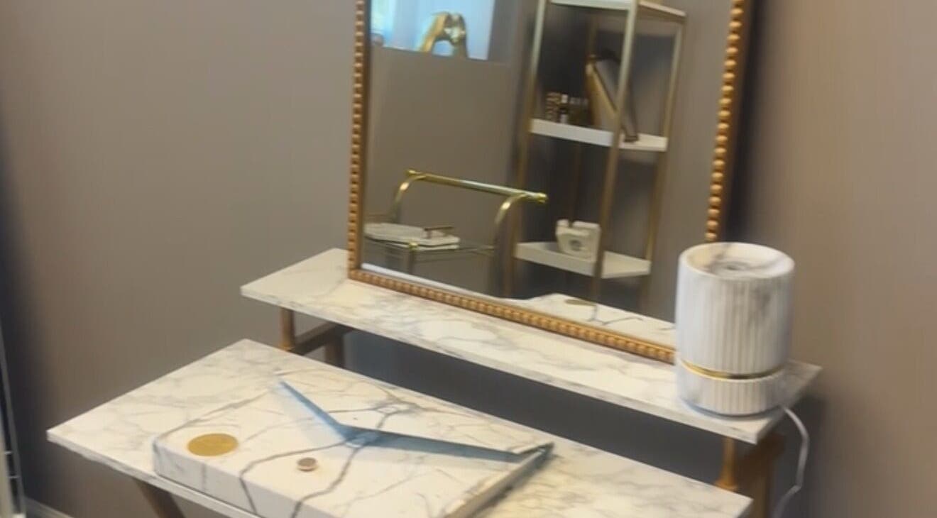Elegant marble vanity with gold accents at Nduljé By Ebony in Crestview, Florida, US.