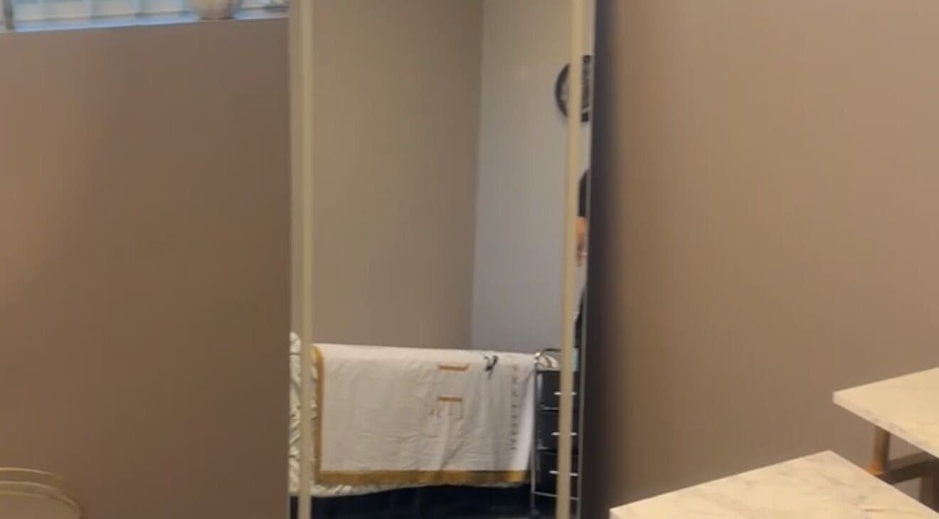 Elegant therapy room at Nduljé By Ebony in Crestview, Florida, US with a large mirror and soft lighting.