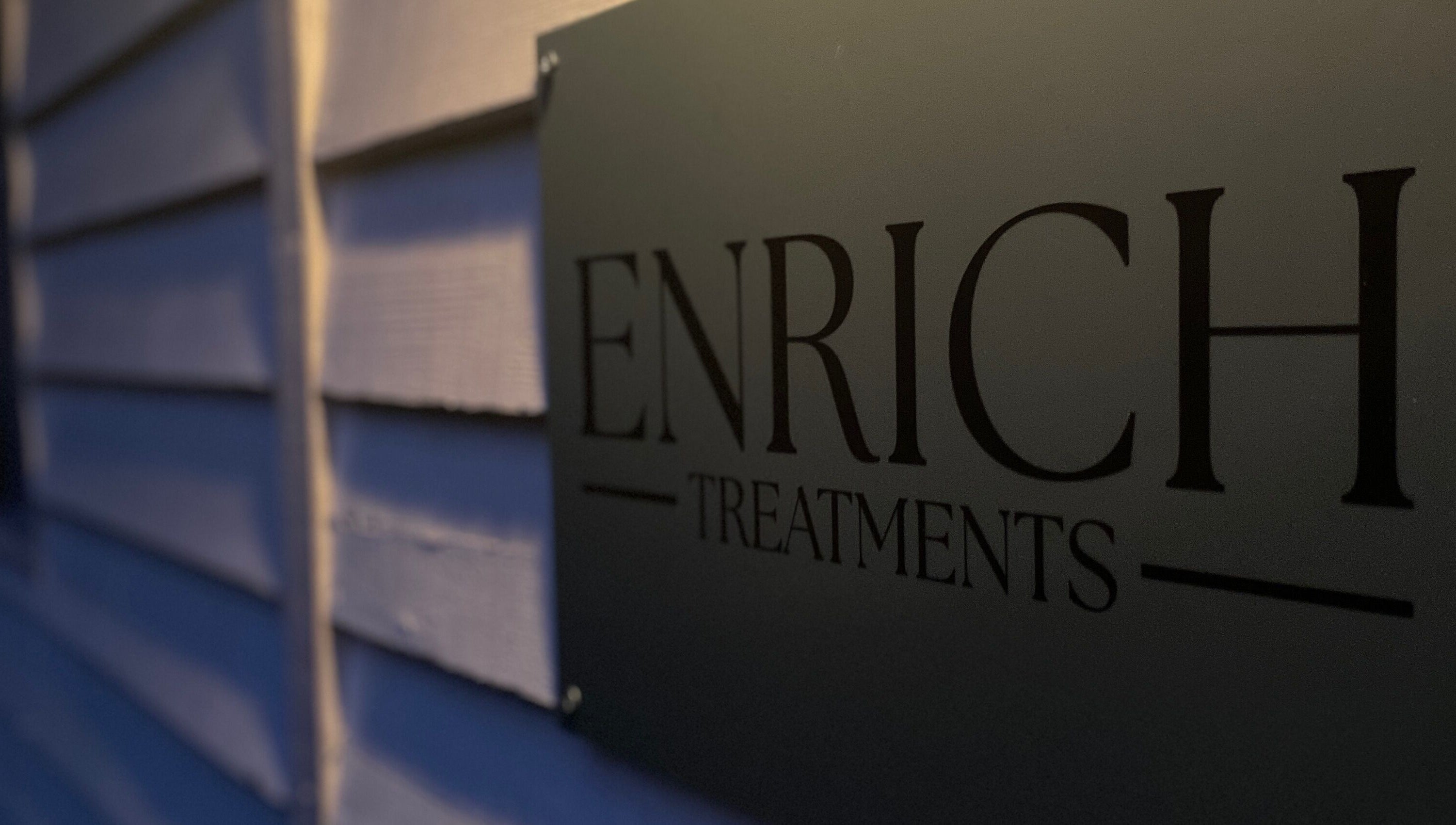Enrich Treatments sign at Saffron Walden, England, GB, showcasing elegance and modern design.