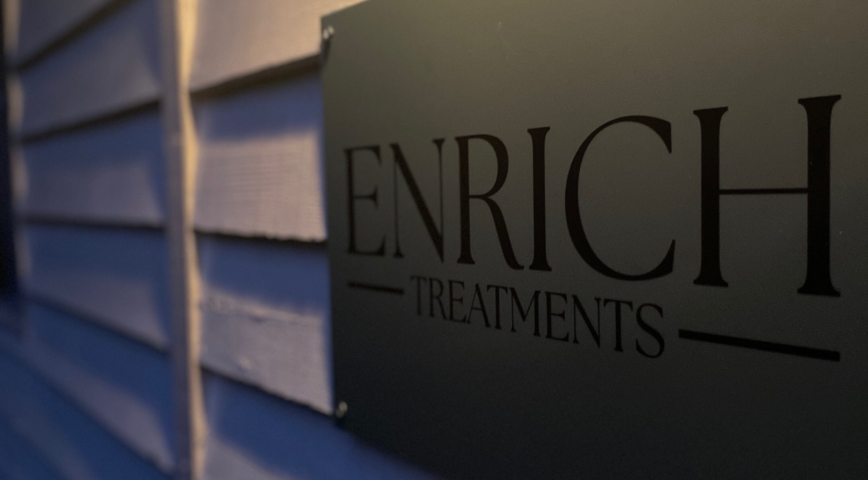 Enrich Treatments sign at Saffron Walden, England, GB, showcasing elegance and modern design.