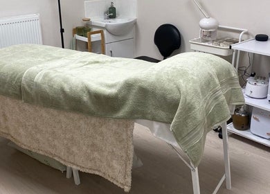 Spa treatment room at Beauty By Tash in Andover, England, GB with a massage table and essential oils.