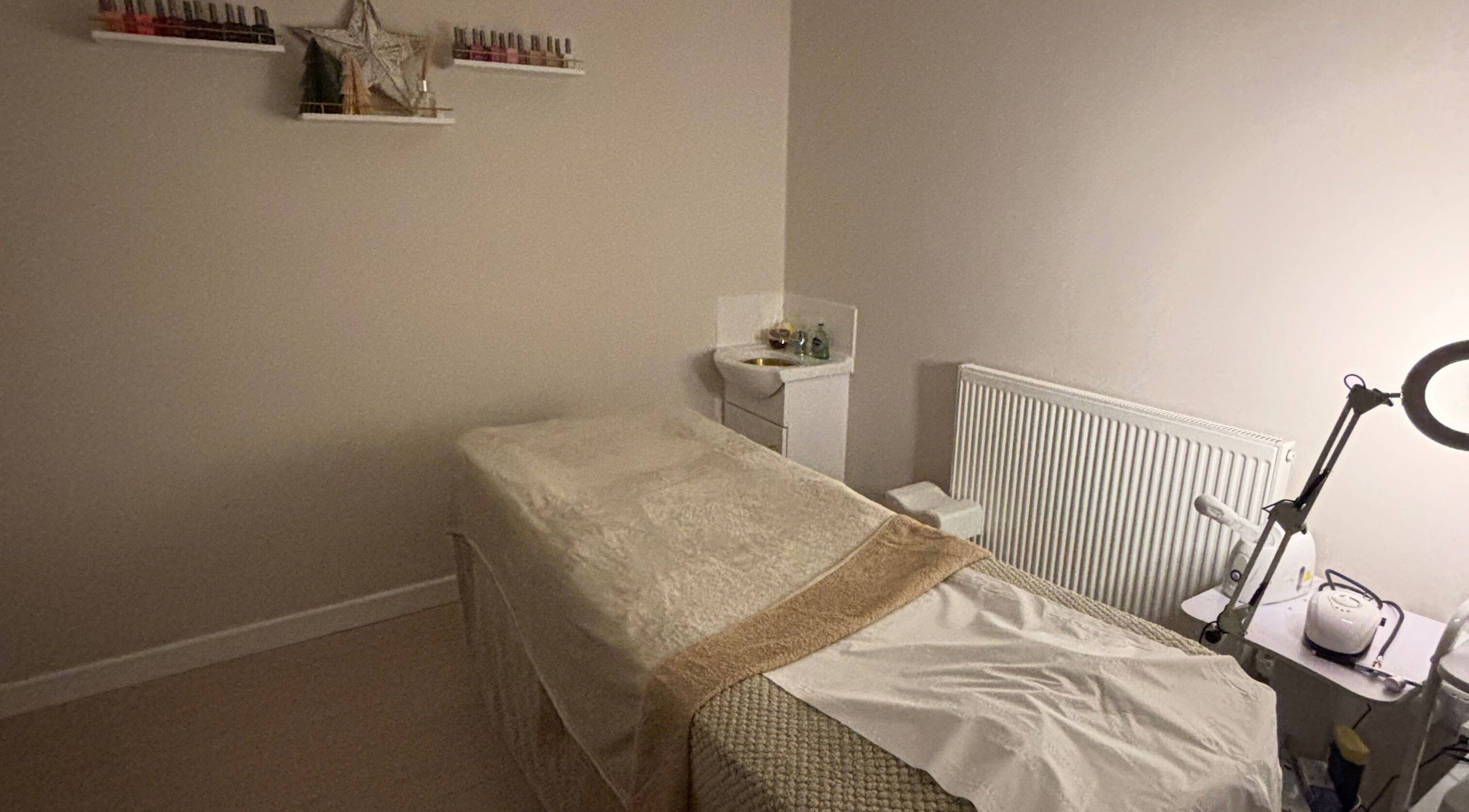 Calm treatment room at Beauty By Tash, Andover, England, GB, featuring a massage table and cozy ambiance.