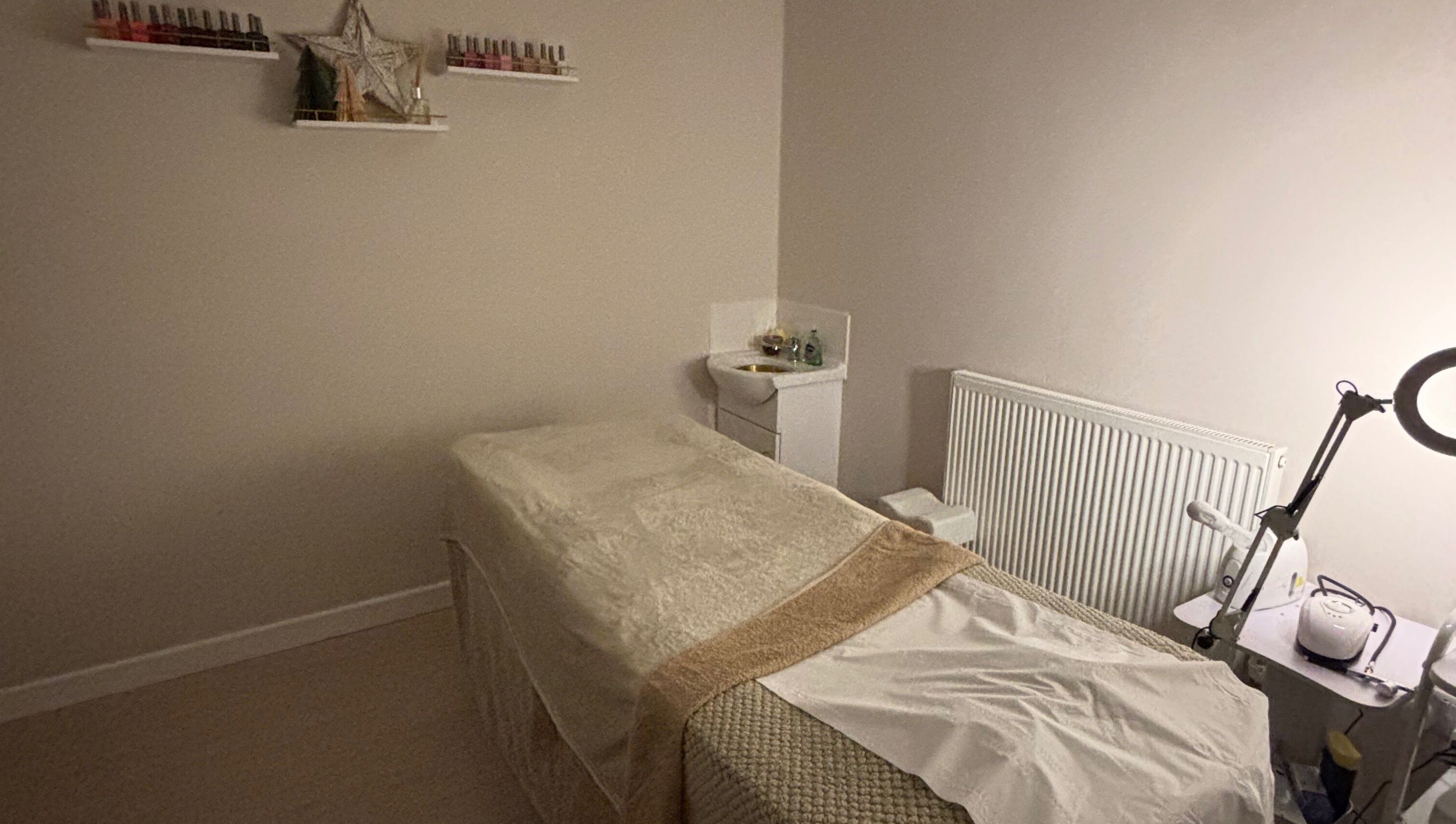 Cozy treatment room at Beauty By Tash in Andover, England, GB, featuring a massage bed and calming decor.