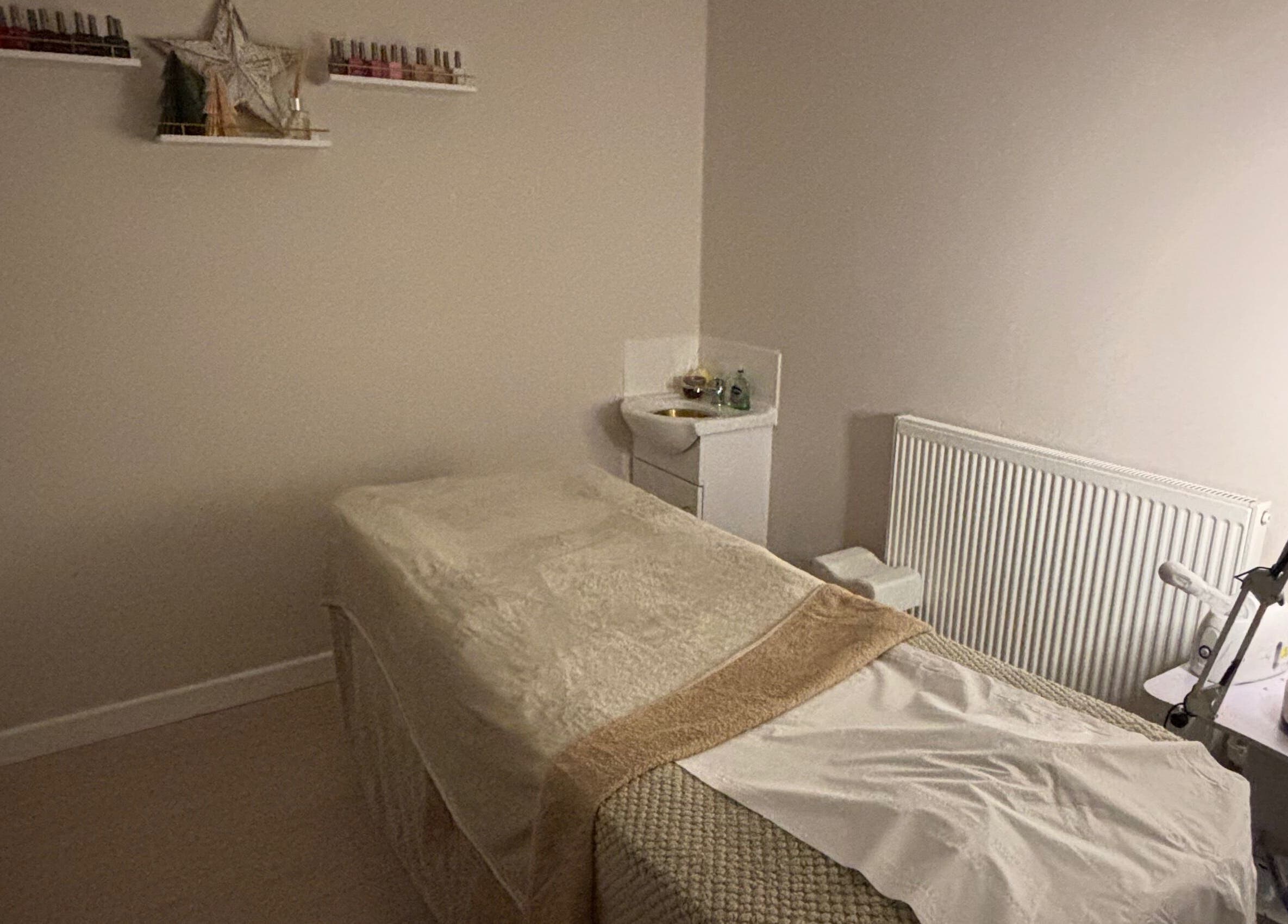 Cozy treatment room at Beauty By Tash in Andover, England, GB, featuring a massage bed and calming decor.