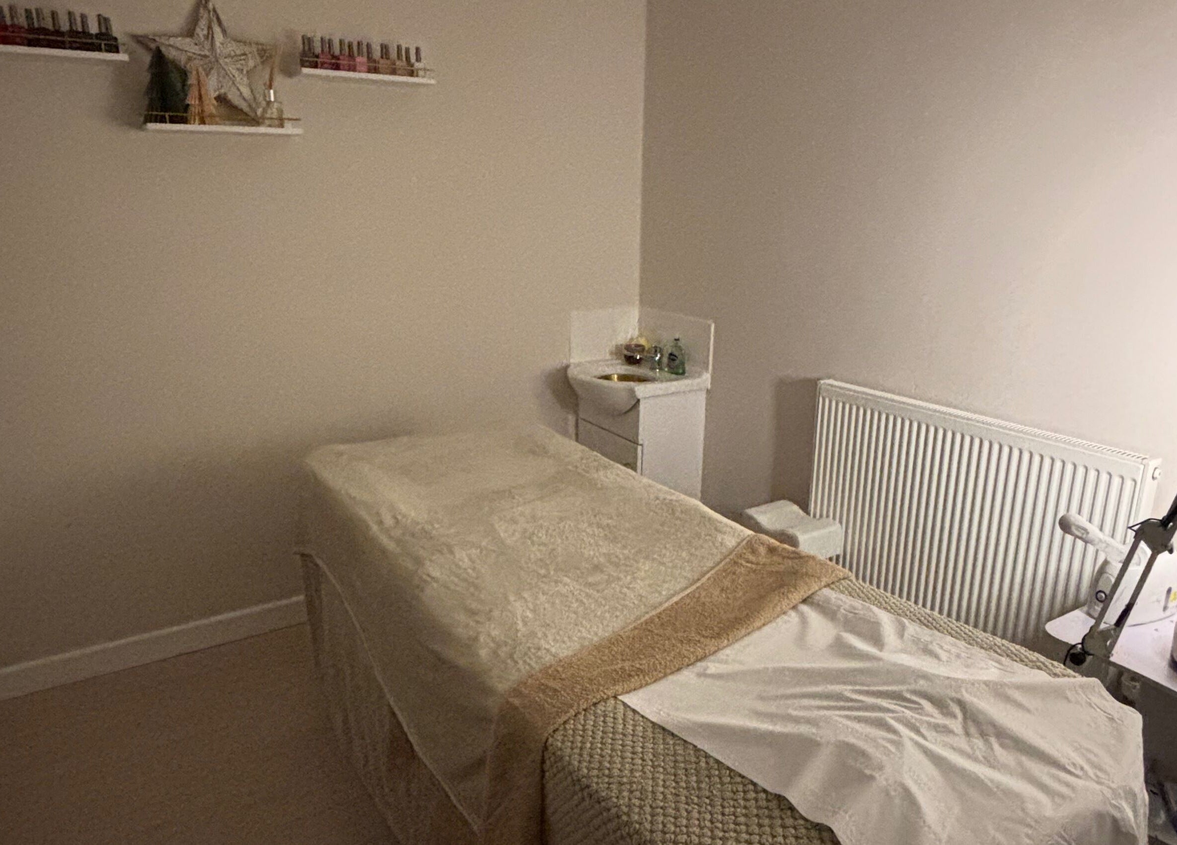 Cozy treatment room at Beauty By Tash in Andover, England, GB, featuring a massage bed and calming decor.