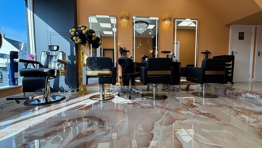 Elegant salon interior at Belinda Ro, WhitleyBay, England with plush chairs and marble flooring.