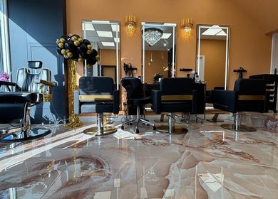 Elegant salon interior at Belinda Ro, WhitleyBay, England with plush chairs and marble flooring.